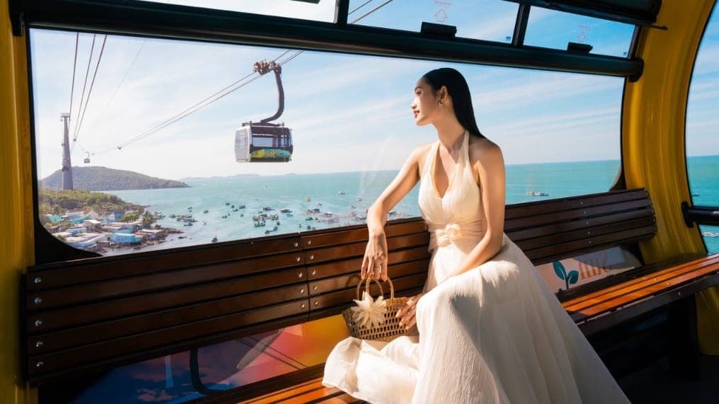 Guest inside the Hon Thom Cable Car looking out over An Thoi harbour and the sea